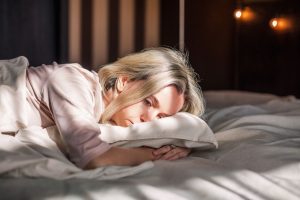 Lady laying in bed feeling depression