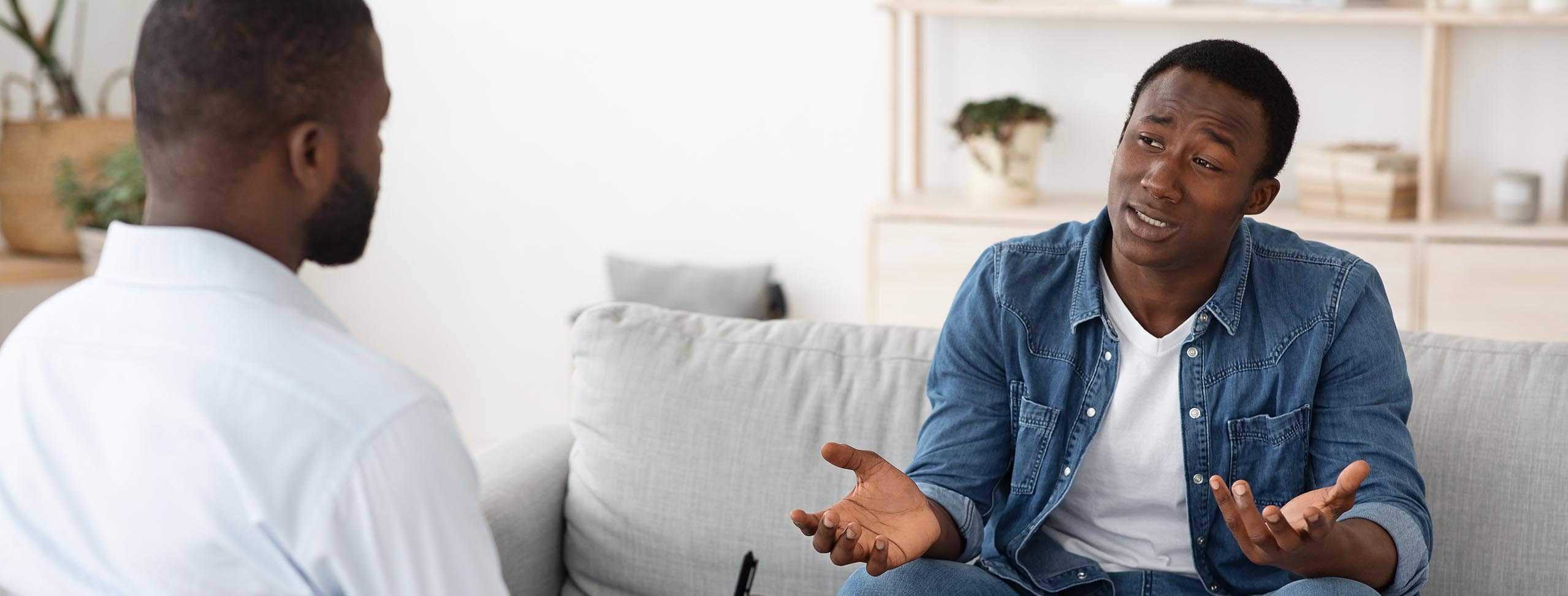 Successful therapy with a black man talking to psychologist