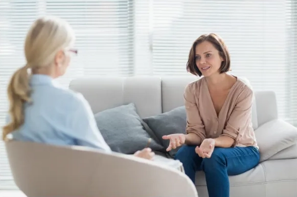 Distressed woman feeling resolve during a therapy session