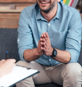 Man expressing happiness during a counselling session