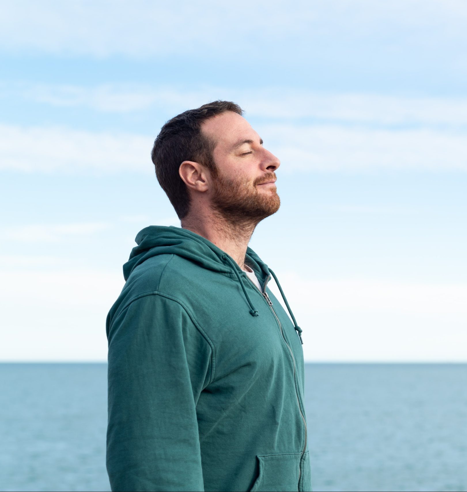 Man relaxing in some outdoor fresh air with eyes closed