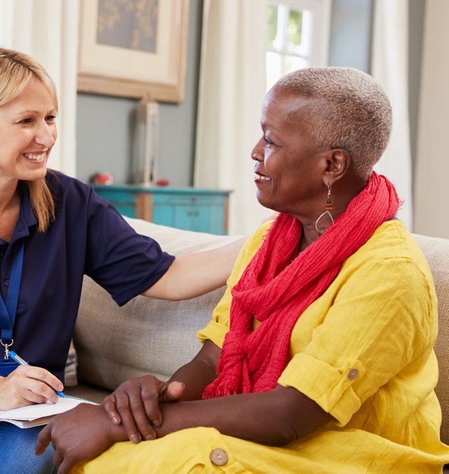 Female support worker visits senior woman at home